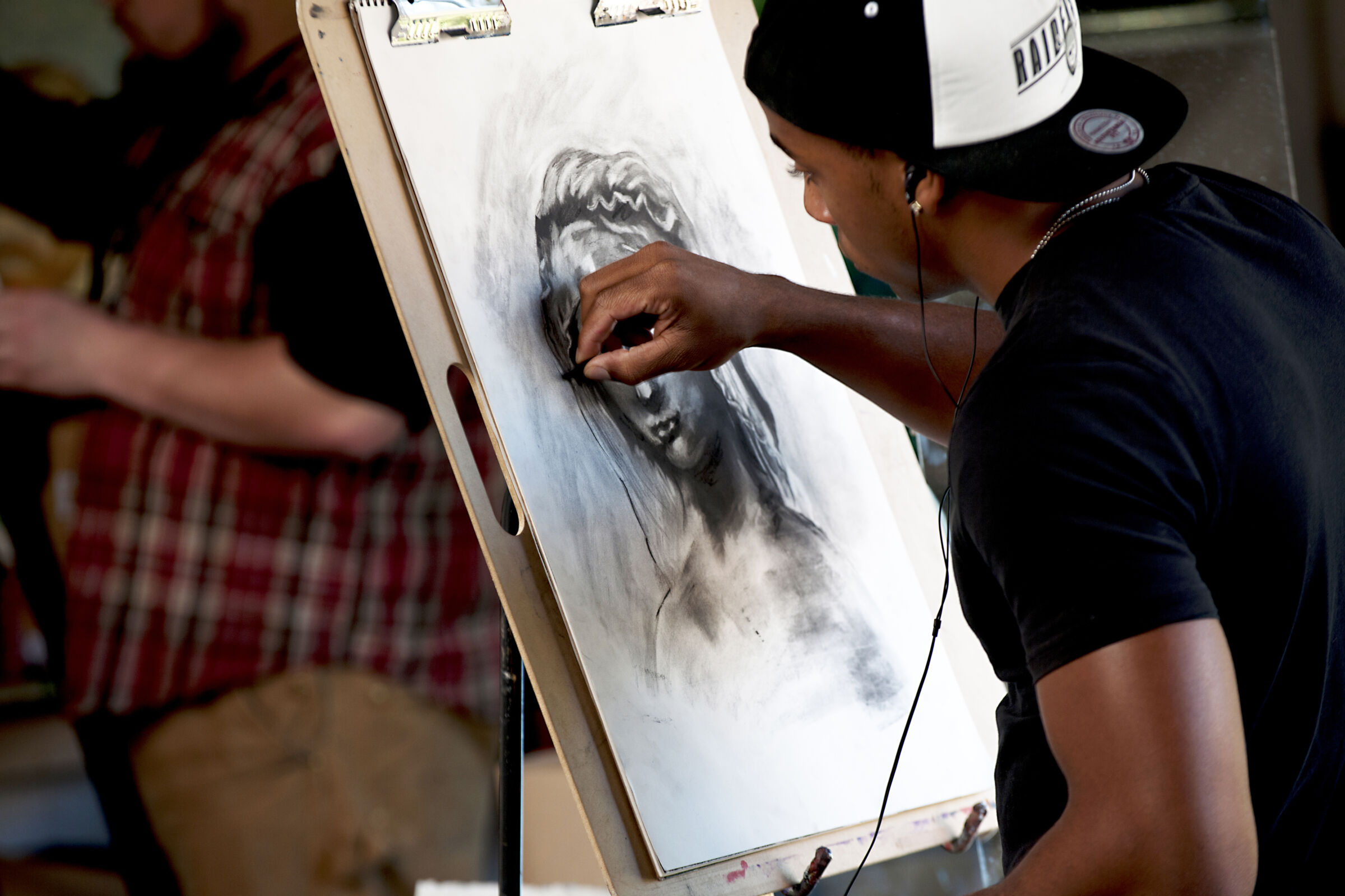 Greensboro College student draws portrait.