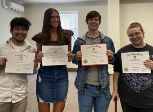 Greensboro College honors students with certificates.