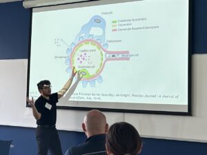 Greensboro College Honors student lecturing in front of a projection screen.